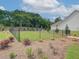 Spacious fenced dog run in backyard with grass and landscaping at 108 Redford Ln, Canton, GA 30115