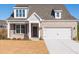 Charming brick home features a two-car garage, manicured lawn, and inviting front entry at 108 Redford Ln, Canton, GA 30115