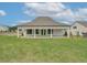 Rear exterior view of a home with a covered patio and manicured lawn at 108 Redford Ln, Canton, GA 30115