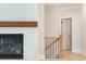 Cozy room features a white-washed brick fireplace with dark mantel and view into stairway at 108 Redford Ln, Canton, GA 30115