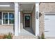 Inviting front porch with brick columns and a charming front door enhances curb appeal at 108 Redford Ln, Canton, GA 30115