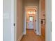 Hallway leading into bathroom with wood flooring and a glimpse of living room at 108 Redford Ln, Canton, GA 30115