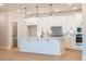 Bright kitchen features a large center island, stainless appliances, and a neutral color scheme at 108 Redford Ln, Canton, GA 30115