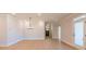 Open-concept room with wood floors, decorative lighting and view into front door and hallway at 108 Redford Ln, Canton, GA 30115