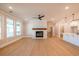 Sunlit living room features hardwood floors, a cozy fireplace, and seamless flow to kitchen at 108 Redford Ln, Canton, GA 30115