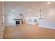 Spacious and bright open-concept living area with wood floors, white kitchen, and a fireplace at 108 Redford Ln, Canton, GA 30115