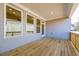 Covered porch with wood flooring, multiple windows, and recessed lighting, perfect for outdoor relaxation at 108 Redford Ln, Canton, GA 30115
