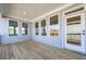 Covered back porch with wooden floors and large windows providing ample light and views at 108 Redford Ln, Canton, GA 30115