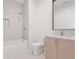 Bright bathroom featuring herringbone tile shower and modern sink with wood cabinets at 1171 Lupo Loop, Chattahoochee Hills, GA 30268