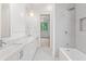 Modern bathroom with double vanity, marble countertop, tub, and shower at 1171 Lupo Loop, Chattahoochee Hills, GA 30268