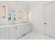 Bright bathroom with double vanity sinks, modern lighting, and framed mirrors at 1171 Lupo Loop, Chattahoochee Hills, GA 30268