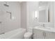 This is a bathroom with tiled walls, a combined tub and shower, and a marble countertop sink at 1171 Lupo Loop, Chattahoochee Hills, GA 30268