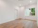 Clean and bright bedroom featuring hardwood floors and large window at 1171 Lupo Loop, Chattahoochee Hills, GA 30268
