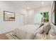 Cozy bedroom with hardwood floors, a large window, and comfortable furnishings at 1171 Lupo Loop, Chattahoochee Hills, GA 30268