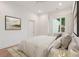 Comfortable bedroom with a neutral color scheme, modern artwork, and natural light at 1171 Lupo Loop, Chattahoochee Hills, GA 30268