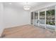 Bonus room with hardwood floors and sliding glass doors to a backyard stone patio at 1171 Lupo Loop, Chattahoochee Hills, GA 30268