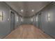 Long hallway featuring hardwood floors, recessed lighting, and paneled walls at 1171 Lupo Loop, Chattahoochee Hills, GA 30268