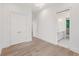 Hallway with hardwood floors leads to a bedroom and a bathroom at 1171 Lupo Loop, Chattahoochee Hills, GA 30268