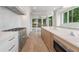 Chef's kitchen features a professional-grade range, custom island, and access to outdoor patio at 1171 Lupo Loop, Chattahoochee Hills, GA 30268