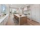 Elegant kitchen featuring a large island with seating, marble countertops, and modern appliances at 1171 Lupo Loop, Chattahoochee Hills, GA 30268
