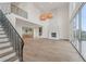 Elegant living room boasts soaring ceilings, a fireplace, and seamless indoor-outdoor flow at 1171 Lupo Loop, Chattahoochee Hills, GA 30268