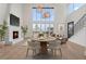 Open-concept living room with a fireplace, modern lighting, and hardwood floors at 1171 Lupo Loop, Chattahoochee Hills, GA 30268