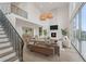 Bright living room features a fireplace, high ceilings, and large windows offering plenty of natural light at 1171 Lupo Loop, Chattahoochee Hills, GA 30268