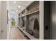 Mudroom with custom-built shelving and lots of storage for shoes and accessories at 1171 Lupo Loop, Chattahoochee Hills, GA 30268