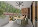 Covered patio with a stone fireplace and outdoor dining area at 1171 Lupo Loop, Chattahoochee Hills, GA 30268