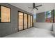 Covered patio features a ceiling fan, tiled flooring, and large sliding doors leading to the indoors at 1171 Lupo Loop, Chattahoochee Hills, GA 30268