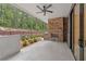Outdoor patio features a stone fireplace, grilling station, ceiling fan, and lovely landscaping at 1171 Lupo Loop, Chattahoochee Hills, GA 30268