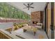 Inviting covered outdoor patio with a stone fireplace and comfortable seating area at 1171 Lupo Loop, Chattahoochee Hills, GA 30268