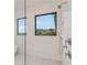 Modern shower featuring a window with a beautiful view and brushed nickel fixtures at 1171 Lupo Loop, Chattahoochee Hills, GA 30268