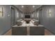 A cozy home theater room with plush seating and dim lighting at 1171 Lupo Loop, Chattahoochee Hills, GA 30268