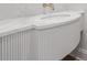 Elegant vanity with marble countertop and curved wooden base with vertical design at 1171 Lupo Loop, Chattahoochee Hills, GA 30268