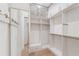 Spacious walk-in closet with custom shelving and built-in storage solutions at 1171 Lupo Loop, Chattahoochee Hills, GA 30268