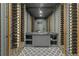 Custom wine cellar with storage, diamond tile and a grey island at 1171 Lupo Loop, Chattahoochee Hills, GA 30268