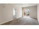 Bright living room with carpet flooring, neutral walls, and a sliding glass door to a balcony at 195 14Th Ne St # 1404, Atlanta, GA 30309