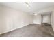 A bare living room featuring carpet, neutral walls, and a ceiling light at 195 14Th Ne St # 1404, Atlanta, GA 30309