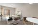 Well-lit living room featuring carpet, neutral walls, comfortable seating, and an access to balcony at 195 14Th Ne St # 1404, Atlanta, GA 30309