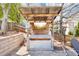 Outdoor backyard bar area featuring corrugated metal, mounted television, and an outdoor seating area at 3530 Horizon Ct, Cumming, GA 30041
