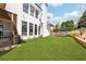 Lush backyard with manicured lawn, well-maintained landscaping, and exterior views of the home's architecture at 3530 Horizon Ct, Cumming, GA 30041