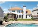 Back exterior of home featuring an in-ground pool, screened in porch, patio, and well-manicured lawn at 3530 Horizon Ct, Cumming, GA 30041