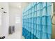 Charming bathroom with a bright blue, layered shower curtain and tiled floors at 3530 Horizon Ct, Cumming, GA 30041