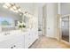 Gorgeous bathroom featuring a double sink vanity, an expansive mirror, a large window, and a glass shower at 3530 Horizon Ct, Cumming, GA 30041