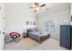 Comfortable bedroom with carpet flooring, ceiling fan, and a window for natural light at 3530 Horizon Ct, Cumming, GA 30041