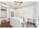 Bonus room with hardwood floors, an island, a built-in desk, white cabinets and stainless steel appliances at 3530 Horizon Ct, Cumming, GA 30041
