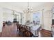 Elegant dining room with hardwood floors, stylish chandelier, and large windows offering ample natural light at 3530 Horizon Ct, Cumming, GA 30041