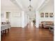 Bright foyer with dark wood floors, white wainscoting and light fixtures at 3530 Horizon Ct, Cumming, GA 30041