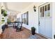 Charming front porch with brick flooring, classic rocking chairs, and a beautifully adorned light blue front door at 3530 Horizon Ct, Cumming, GA 30041